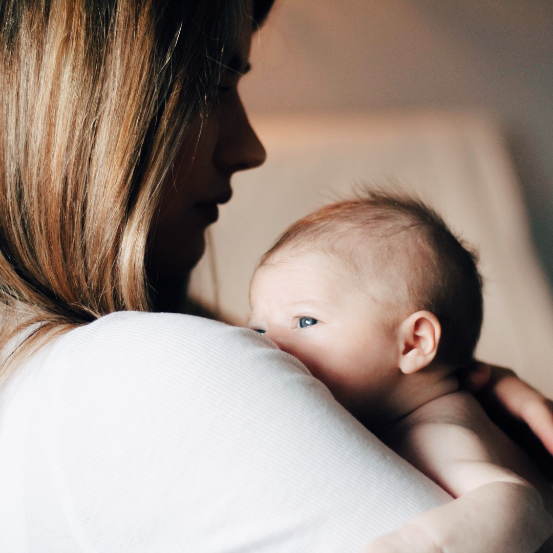 Mother Cradling Newborn Baby