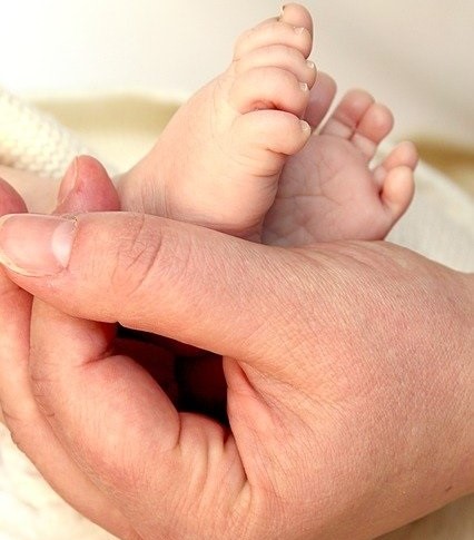 Woman holding babys feet